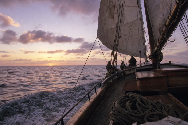 Historic wooden schooner under full sail off Key West at sunset