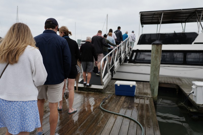Guests boarding a sunset cruise boat at a Key West marina in the late afternoon