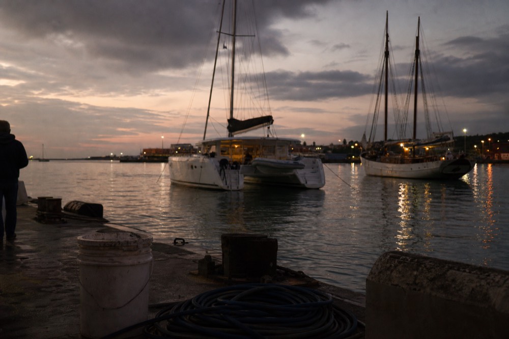 Catamaran and schooner anchored near the Historic Seaport at dusk, no text, no logos, no people