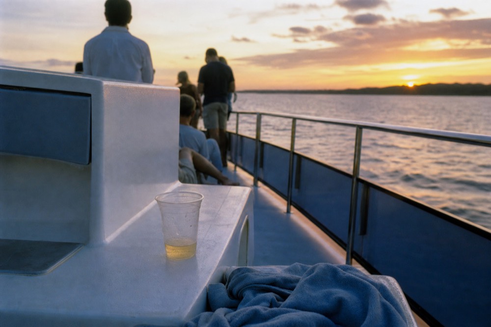 Catamaran deck crowded with sunset light over Key West harbor, no text, no logos, no people
