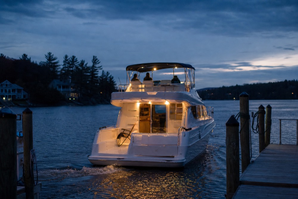 Cruise boat returning at twilight, no text, no logos, no people