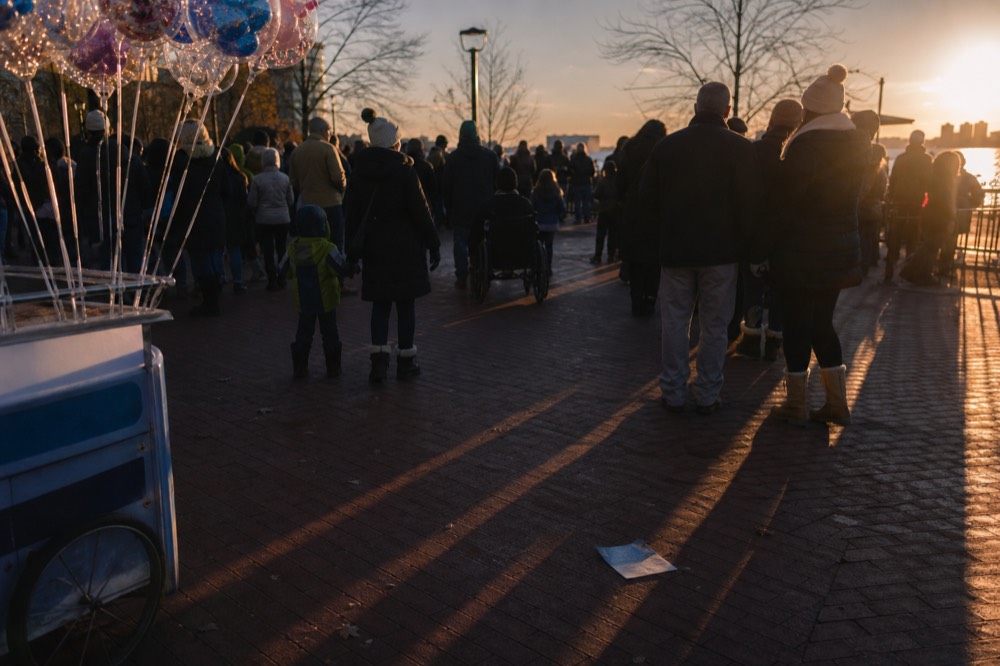 Crowds gathered along a Key West waterfront plaza facing the setting sun, no text, no logos, no people.
