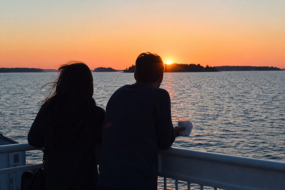 A couple's silhouette against a brilliant orange Key West sunset from the deck of a boat, no text, no logos, no people.