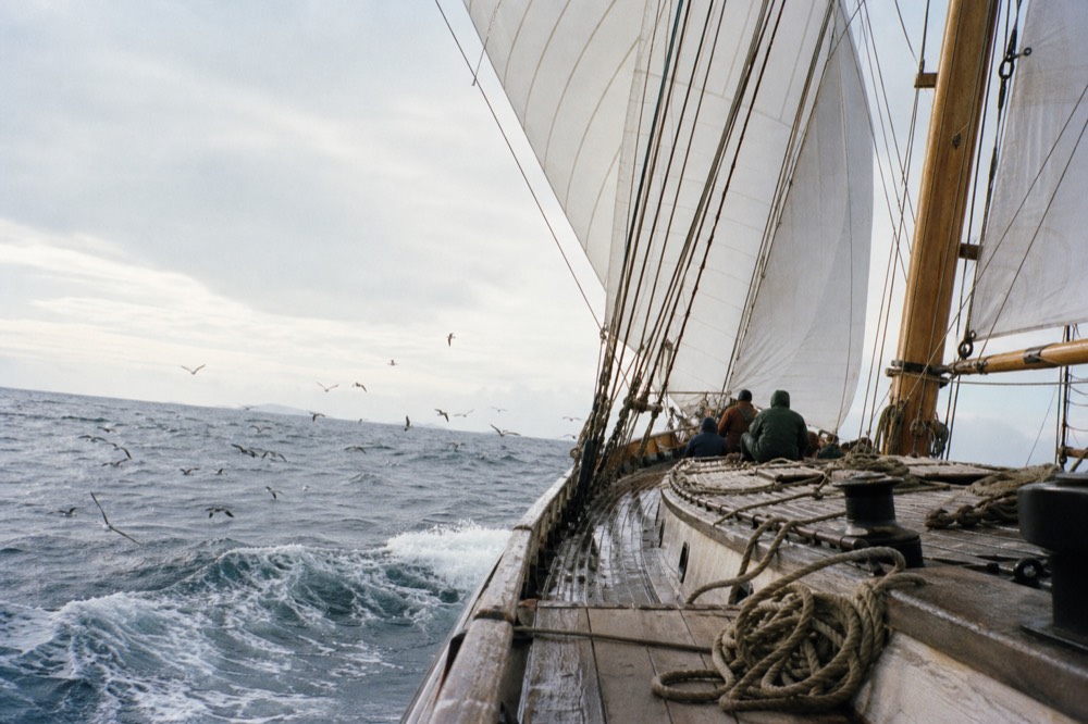 A tall schooner heeling under full canvas in open water near Key West, no text, no logos, no people