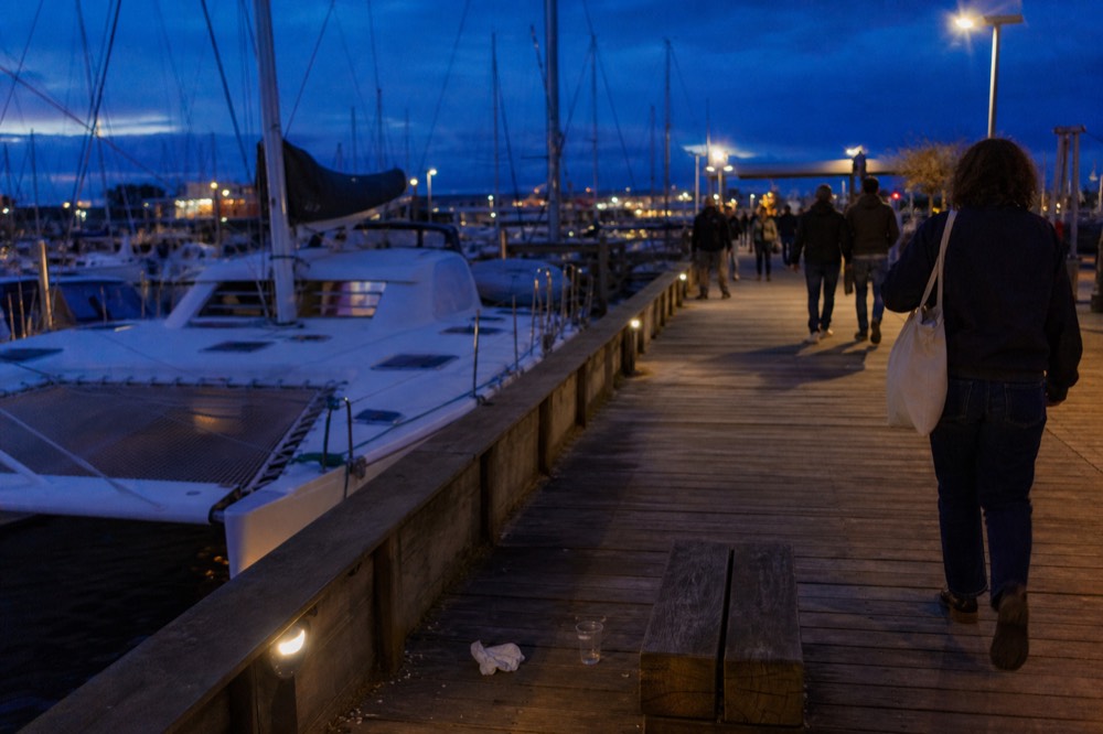 The Key West Historic Seaport waterfront at dusk with masts and catamaran hulls at the docks, no text, no logos, no people