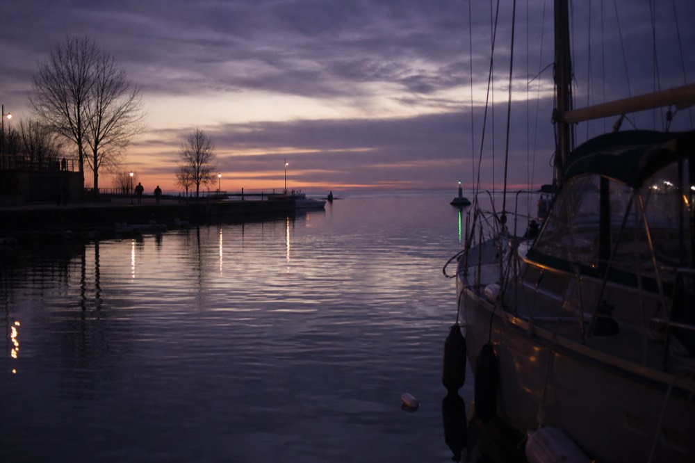 A Key West harbor at twilight with several sailboats moored, purple sky, no text, no logos, no people