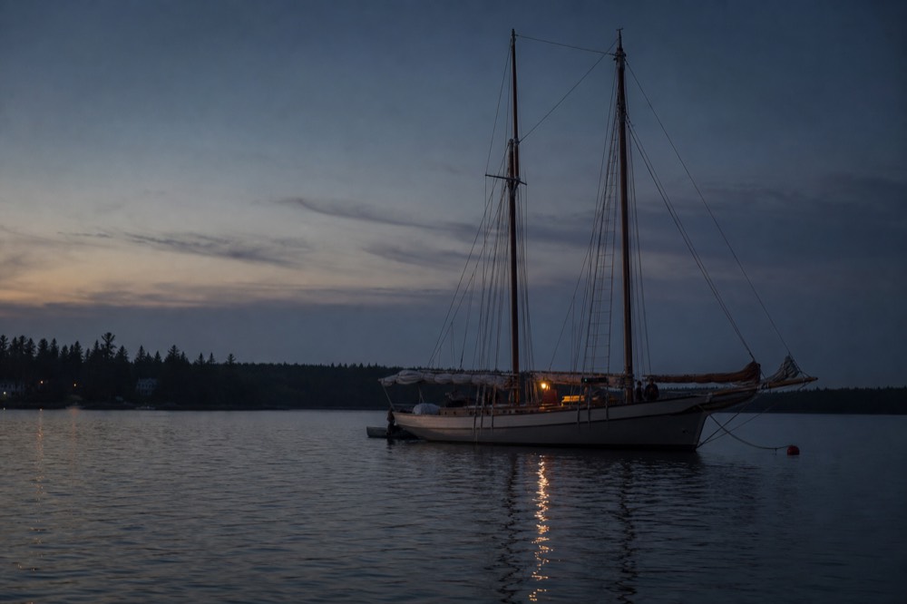 A tall sailing ship at anchor near the Key West waterfront at dusk, no text, no logos, no people