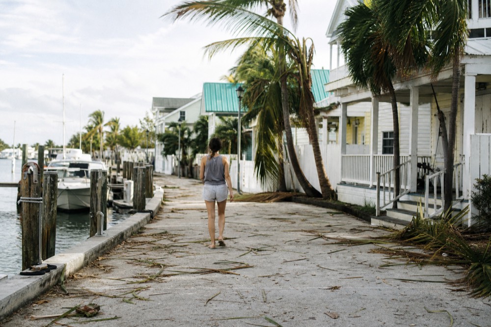 A flat waterfront walkway between the Historic Seaport marina and old Conch-style buildings in Key West, no text, no logos, no people