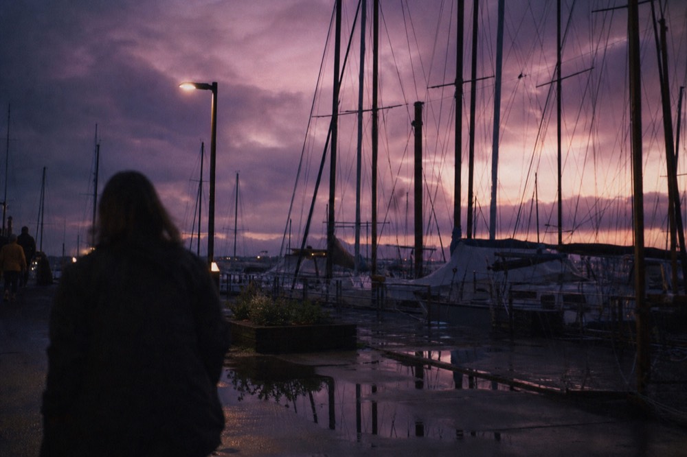 Twilight over the Key West Historic Seaport with sailboat masts silhouetted against a purple sky, no text, no logos, no people